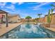 Backyard pool and patio area with lounge and dining seating, landscaping, and tranquil ambiance at 3690 E Blue Spruce Ln, Gilbert, AZ 85298