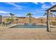 Swimming pool with a waterfall feature set amidst tropical palm trees and beautiful landscaping at 3690 E Blue Spruce Ln, Gilbert, AZ 85298