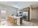 Open kitchen with stainless steel appliances, island with bar seating, and modern pendant lighting at 3735 E Kenley Ln, San Tan Valley, AZ 85143