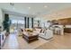 Spacious living room featuring an open floorplan, modern sofa, and lots of natural light at 3735 E Kenley Ln, San Tan Valley, AZ 85143