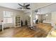 Spacious bedroom area with sliding mirror closet doors, hardwood floors and ceiling fan at 40729 W Coltin Way, Maricopa, AZ 85138