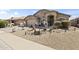 Inviting single-level home featuring desert landscaping, a decorative bridge, and a welcoming entrance at 40729 W Coltin Way, Maricopa, AZ 85138