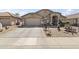 Attractive single-story home boasts a two-car garage and drought-tolerant landscaping with decorative touches at 40729 W Coltin Way, Maricopa, AZ 85138