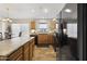 Functional kitchen includes wood cabinets, modern appliances, and a view of the eat-in kitchen at 40729 W Coltin Way, Maricopa, AZ 85138