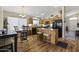 Eat-in kitchen featuring wood cabinets, an island with seating, and modern black appliances at 40729 W Coltin Way, Maricopa, AZ 85138