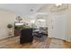 Cozy living room features wood floors, neutral decor, and comfortable seating near the front door at 40729 W Coltin Way, Maricopa, AZ 85138