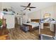 Main bedroom boasts hardwood floors, ceiling fan, and doorway to main bath at 40729 W Coltin Way, Maricopa, AZ 85138