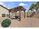 Backyard pergola with outdoor seating and landscaping provides an ideal space for relaxation and entertainment at 40729 W Coltin Way, Maricopa, AZ 85138