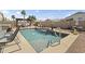 Backyard pool features a waterfall and hot tub with seating area and pergola-covered dining area, ideal for outdoor living at 40729 W Coltin Way, Maricopa, AZ 85138