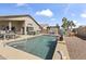 Inviting backyard pool area with a hot tub, pergola, and seating, perfect for outdoor entertaining and relaxation at 40729 W Coltin Way, Maricopa, AZ 85138