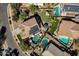 Aerial view of home with a swimming pool, hot tub, solar panels, trampoline, and playground at 4144 E Blossom Ct, Gilbert, AZ 85297