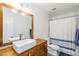 This stylish bathroom features a modern vessel sink, wood vanity, and shower-tub combination at 4402 E Montecito Ave, Phoenix, AZ 85018