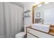 Cozy bathroom featuring a modern floating sink with wooden accents and decorative shelving at 4402 E Montecito Ave, Phoenix, AZ 85018