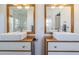 Modern bathroom featuring double sinks with wood cabinets and chrome faucets at 4402 E Montecito Ave, Phoenix, AZ 85018