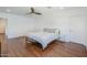 Minimalist bedroom with hardwood floors, white walls, a ceiling fan, and a metal bed frame at 4402 E Montecito Ave, Phoenix, AZ 85018