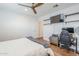 This bright bedroom is equipped for work or play with a wall-mounted TV, shelves and a workspace at 4402 E Montecito Ave, Phoenix, AZ 85018