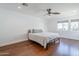 Simple bedroom with hardwood floors, neutral walls, a ceiling fan, and a window at 4402 E Montecito Ave, Phoenix, AZ 85018