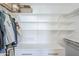 Bright closet featuring built-in shelving, drawers and clothing rods at 4402 E Montecito Ave, Phoenix, AZ 85018