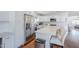 Open kitchen with stainless steel appliances, marble countertops, white cabinets, and a center island at 4402 E Montecito Ave, Phoenix, AZ 85018