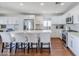 Modern kitchen featuring white cabinets, stainless steel appliances, a large island, and hardwood floors at 4402 E Montecito Ave, Phoenix, AZ 85018