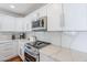 Stylish kitchen with white cabinets, stainless steel microwave, and sleek countertops, perfect for cooking at 4402 E Montecito Ave, Phoenix, AZ 85018