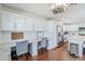 Open concept kitchen and office nook with stainless steel refrigerator, white cabinets, and hardwood floors at 4402 E Montecito Ave, Phoenix, AZ 85018