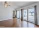 Spacious living room with hardwood floors, sliding glass doors to the patio, and modern lighting at 4402 E Montecito Ave, Phoenix, AZ 85018