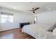 Spacious main bedroom featuring hardwood floors, modern ceiling fan, and a dresser at 4402 E Montecito Ave, Phoenix, AZ 85018