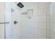 Modern shower with sleek white tiling, rainfall shower head and built-in shelving at 4402 E Montecito Ave, Phoenix, AZ 85018