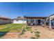 Expansive backyard featuring a patio with seating, lawn space, and exterior view of the house at 4521 W Clarendon Ave, Phoenix, AZ 85031