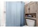 Cozy bathroom with a shower with curtain and cabinet at 4521 W Clarendon Ave, Phoenix, AZ 85031