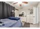 Comfortable bedroom with a ceiling fan, white furniture, and view of a small desk at 4521 W Clarendon Ave, Phoenix, AZ 85031