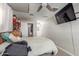 Bedroom with a bed, ceiling fan, TV, and doorway to a closet and other rooms at 4521 W Clarendon Ave, Phoenix, AZ 85031