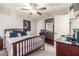 Cozy bedroom featuring dark wood furniture, ceiling fan, and neutral-toned walls at 4521 W Clarendon Ave, Phoenix, AZ 85031