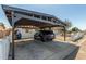 A carport providing shaded parking beside a charming single-story home with a white exterior at 4521 W Clarendon Ave, Phoenix, AZ 85031