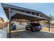 A carport providing shaded parking beside a charming single-story home with a white exterior at 4521 W Clarendon Ave, Phoenix, AZ 85031