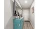 Hallway featuring a blue dresser, decorated mirror, and light gray walls at 4521 W Clarendon Ave, Phoenix, AZ 85031
