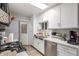 Well-lit kitchen featuring white cabinets, quartz countertops, stainless steel appliances, and modern fixtures at 4521 W Clarendon Ave, Phoenix, AZ 85031