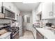 Modern kitchen features stainless steel appliances, sleek white cabinetry, and a well-designed layout for efficiency at 4521 W Clarendon Ave, Phoenix, AZ 85031