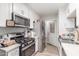 Efficient kitchen with stainless steel appliances, white cabinets, and ample counter space for meal preparation at 4521 W Clarendon Ave, Phoenix, AZ 85031