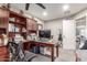 Functional home office with built-in shelving, a large desk, and a neutral color scheme for a productive workspace at 4521 W Clarendon Ave, Phoenix, AZ 85031