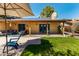 Expansive backyard with covered patio, solar panels, and vibrant green grass at 4839 E Marilyn Rd, Scottsdale, AZ 85254