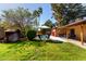 Lush backyard features a pool, mature trees, seating area, and covered patio at 4839 E Marilyn Rd, Scottsdale, AZ 85254