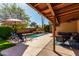 Beautifully landscaped backyard featuring refreshing pool, patio seating, and sunny skies at 4839 E Marilyn Rd, Scottsdale, AZ 85254