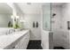 Bathroom featuring double sinks, marble countertops, and a glass shower with gray and white tiling at 4839 E Marilyn Rd, Scottsdale, AZ 85254