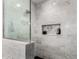 Luxurious bathroom featuring sleek glass shower with rain shower head and tile niche with decor at 4839 E Marilyn Rd, Scottsdale, AZ 85254