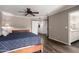 Comfortable bedroom featuring wood floors, a ceiling fan, and an en-suite bathroom at 4839 E Marilyn Rd, Scottsdale, AZ 85254