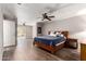 Large primary bedroom with a ceiling fan, wood floors, and access to the backyard at 4839 E Marilyn Rd, Scottsdale, AZ 85254
