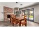 Inviting dining room with a brick fireplace, wooden table and chairs, and sliding glass doors to the backyard at 4839 E Marilyn Rd, Scottsdale, AZ 85254