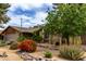 Single-story home featuring desert landscaping and a lush green tree at 4839 E Marilyn Rd, Scottsdale, AZ 85254